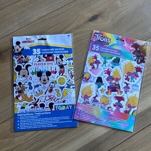 Mickey Mouse and trolls tattoos